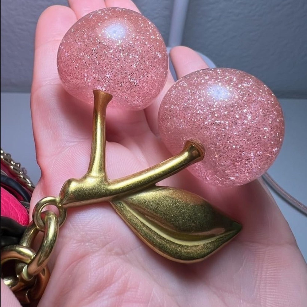 Cherry Pink sparkles with gold leaf clips onto your coach purse